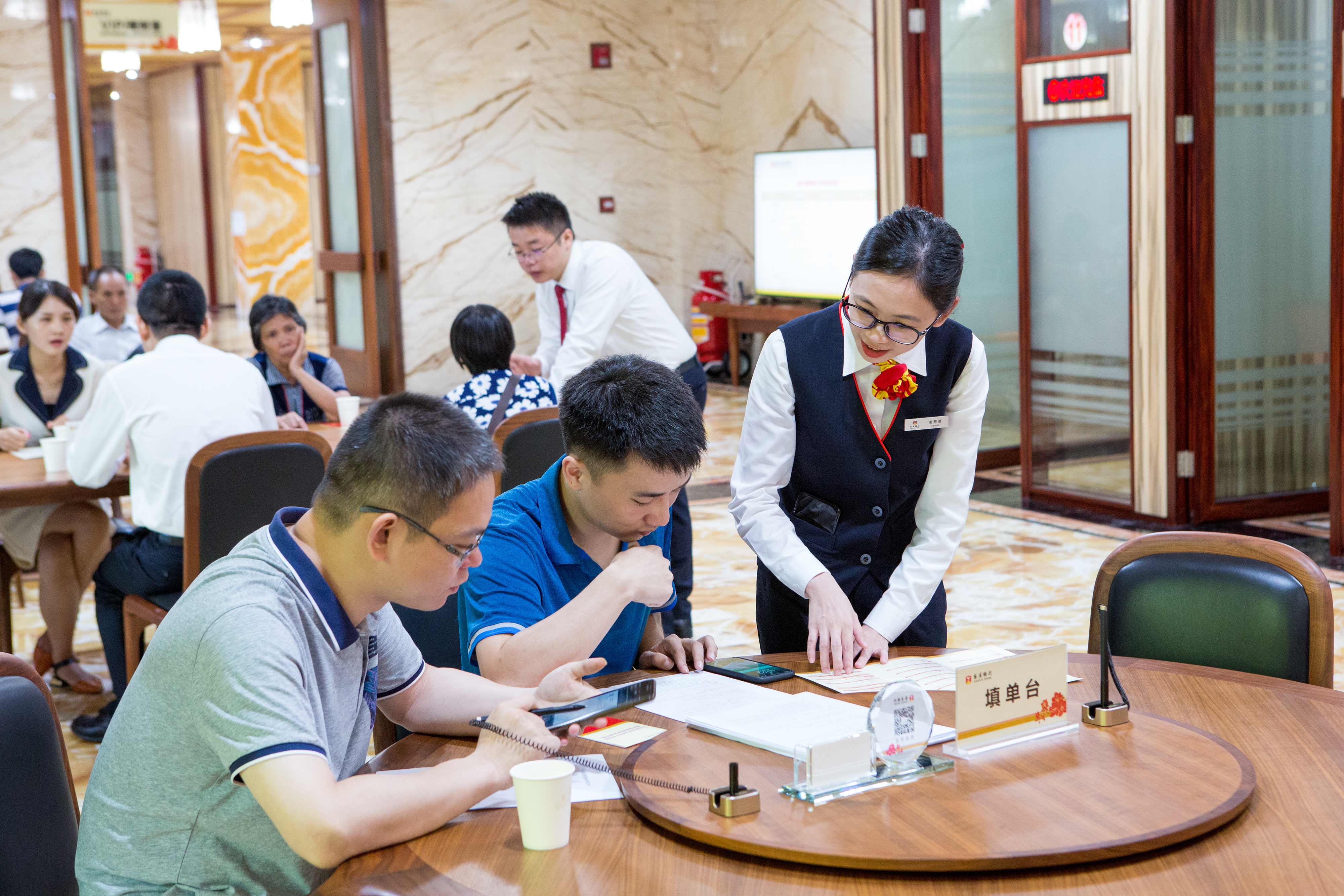 梅州客商银行工作人员与客户亲切交流。 梅州客商银行工作人员与客户亲切交流。