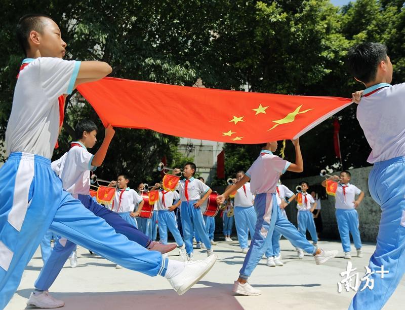 东沙小学的升旗仪式上，国旗护卫队同学护送国旗。