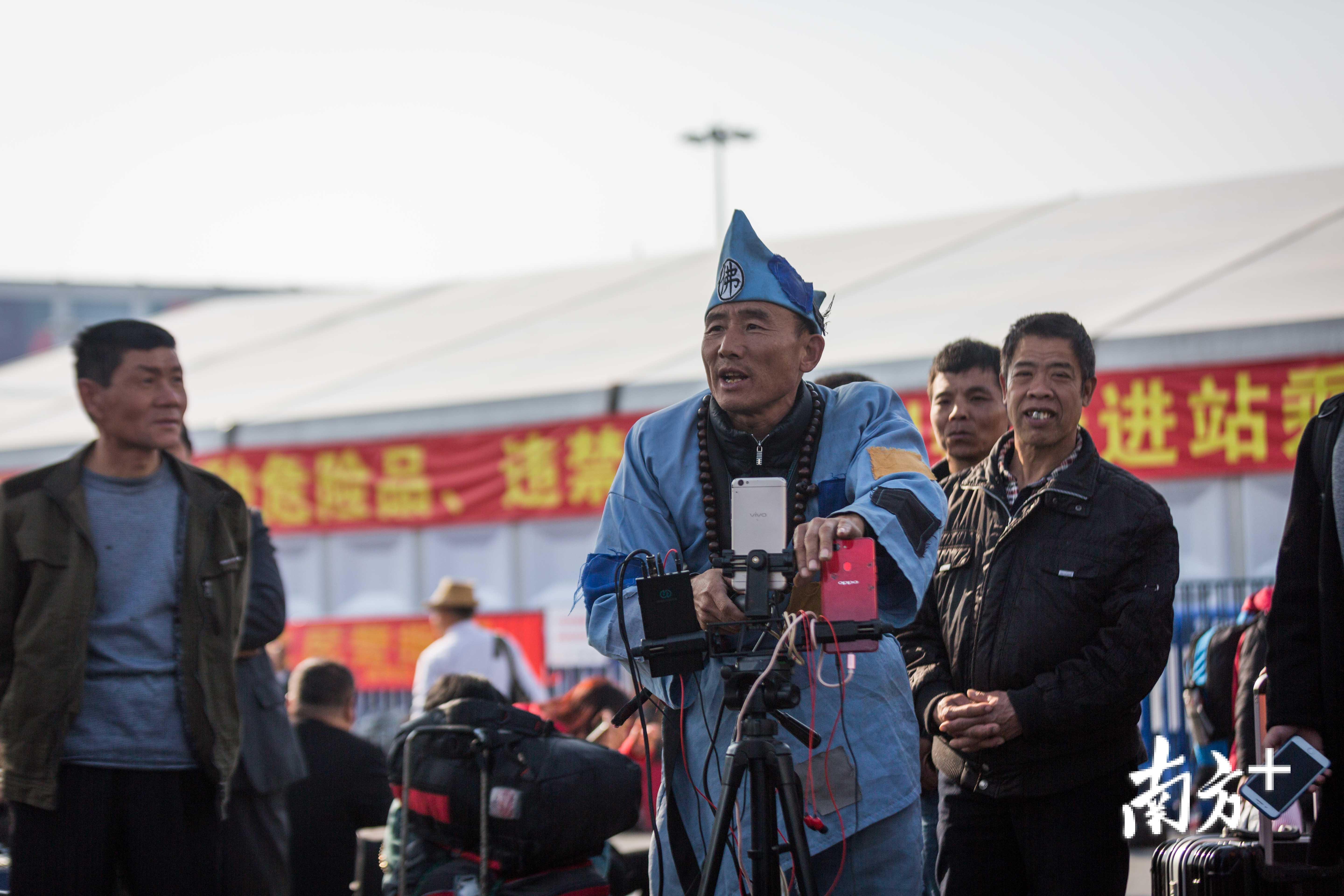 火车站前广场上，一位网络主播正准备直播春运现场。