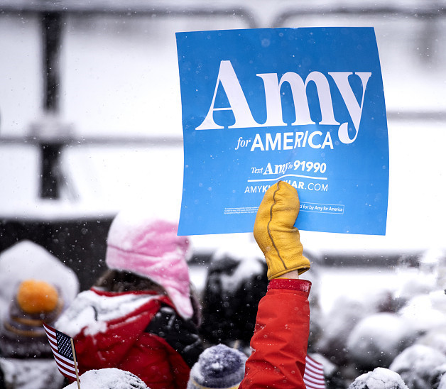 埃米·克洛布彻的支持者高举“埃米代表美国”的标语。新华社发