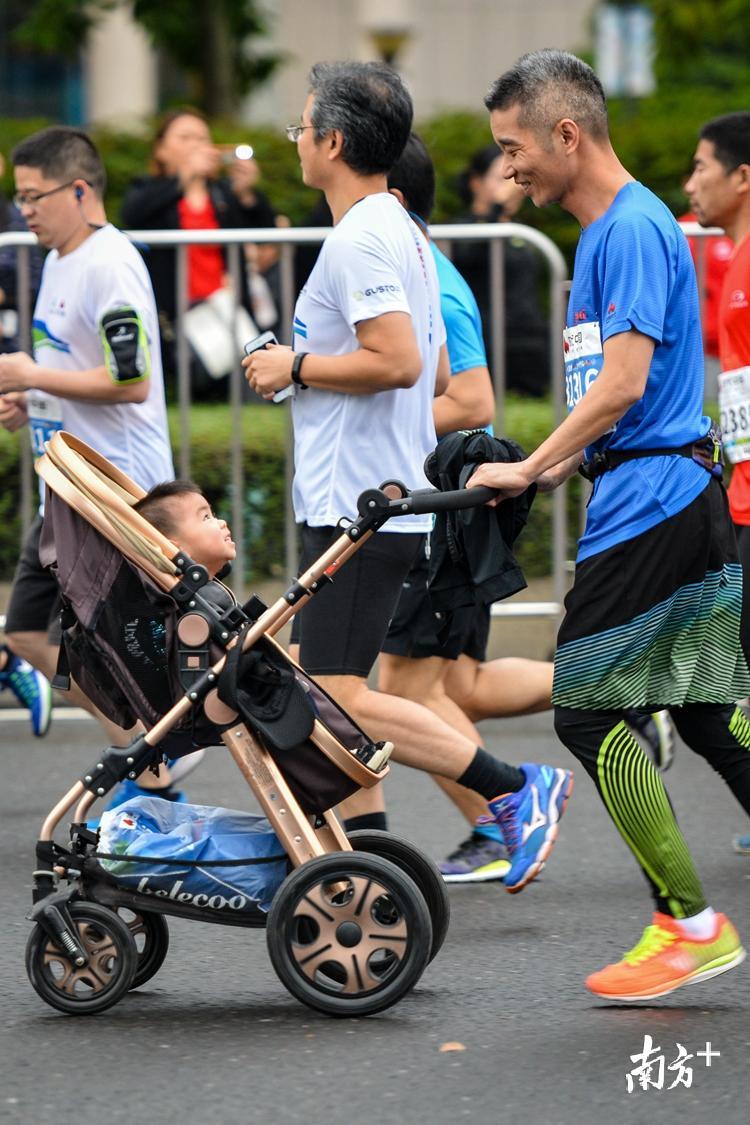 坐着婴儿车跟着家长跑的小朋友,清远马拉松赛会等你长大.曾亮超 摄