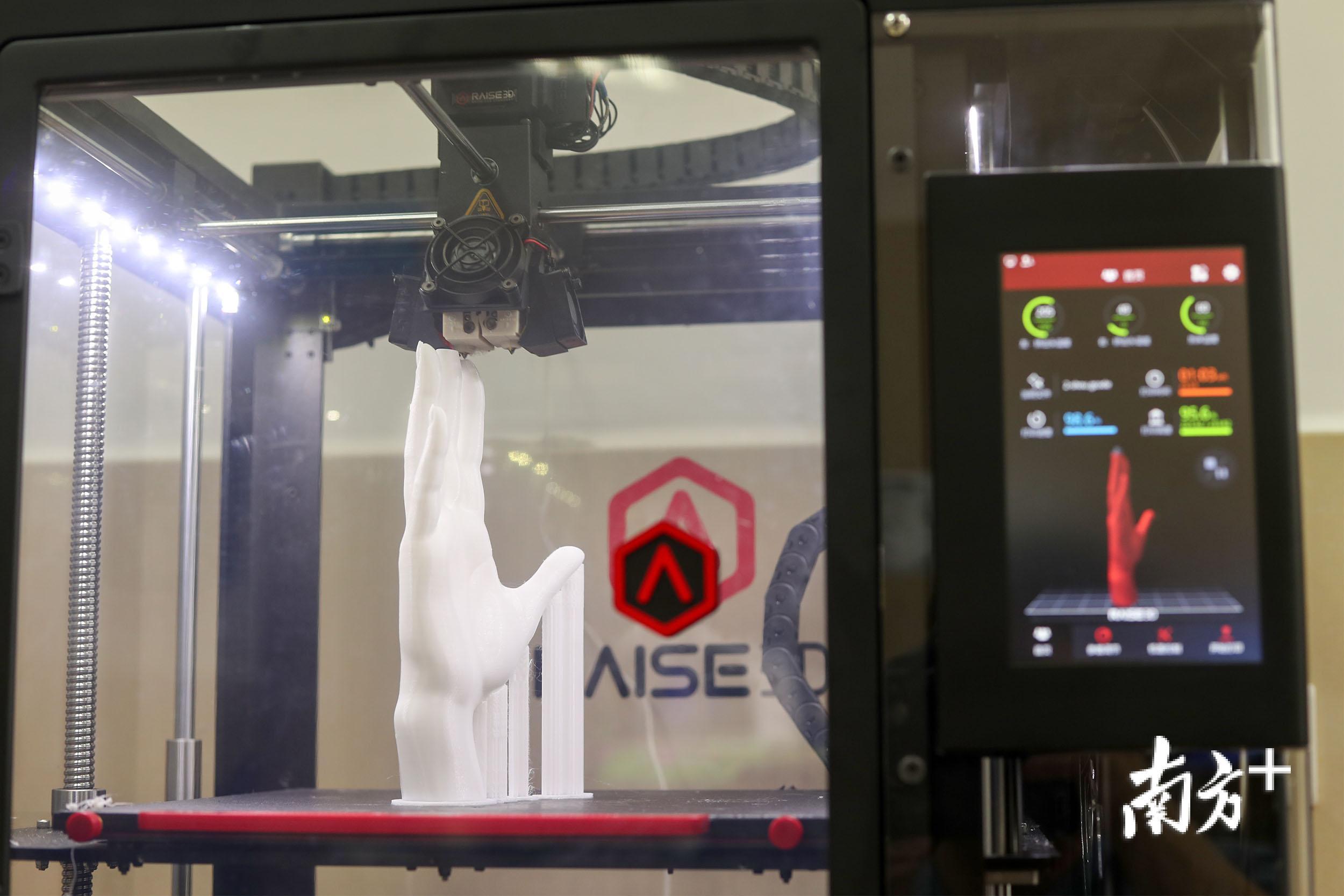 正在打印手部模型的3D打印机。