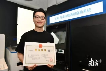 香港市民郑翰衍通过佛山南海设在香港的自助服务终端，远程办出南海营业执照。南方日报记者 戴嘉信 摄