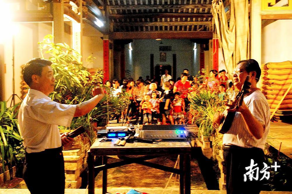 竹板歌省、市级传承人钟柳红、钟伟华在坭陂古民居厅堂内为群众表演竹板歌说唱。（兴宁市文化馆供图）