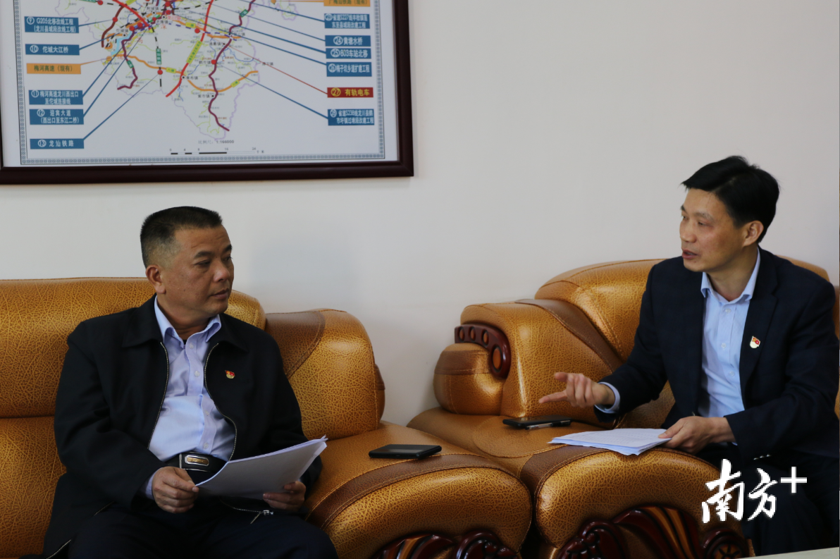 赤光镇委书记吴雄章（右）、镇长刁华昌（左）介绍灾后重建家园情况。