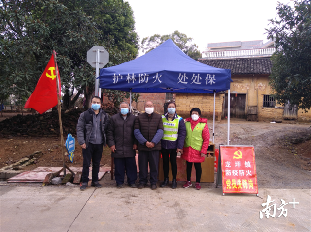 垦区村老党员志愿到村口值守。