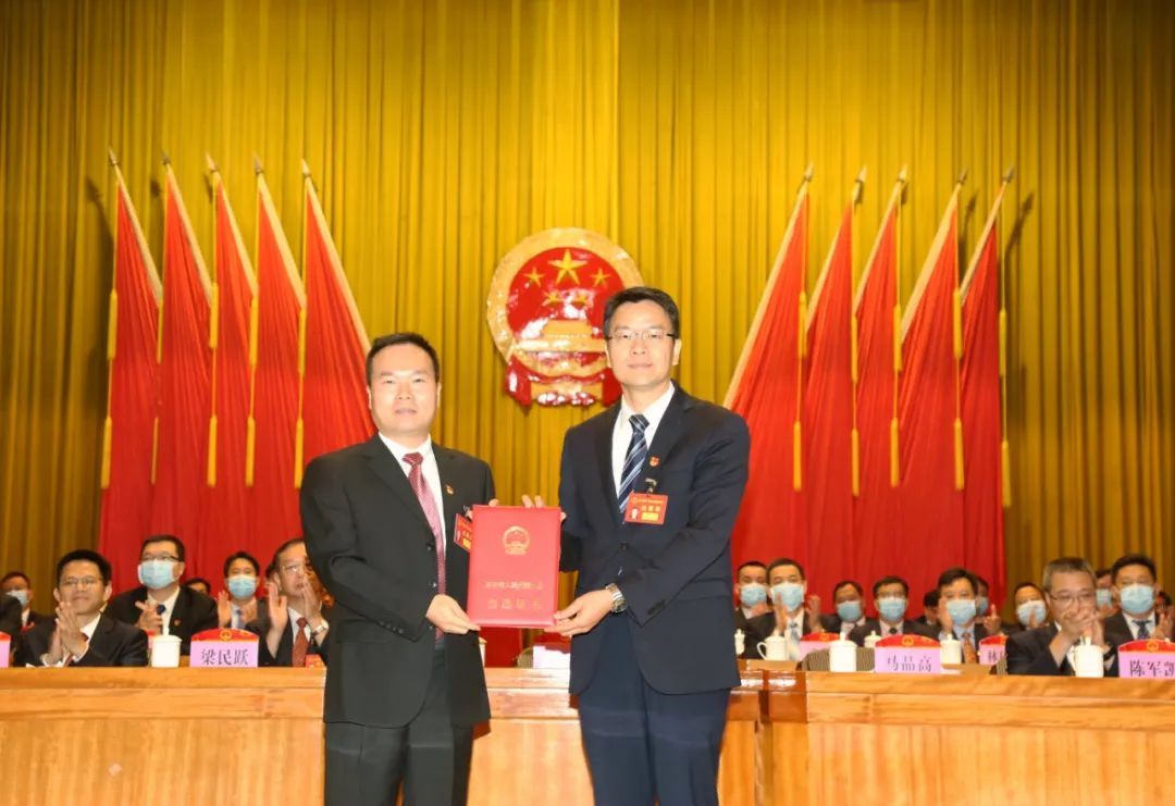 开平市委书记、大会主席团常务主席庞正华为马品高颁发当选证书。