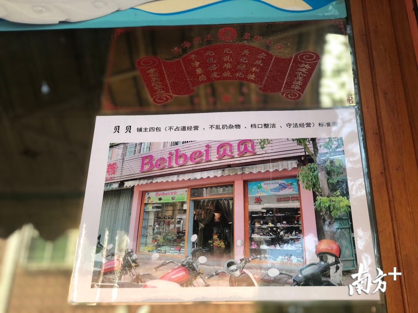 滨海内街的商铺，张贴有专属的“门前四包”标准化样图，供业主实时比对、自我规范。余丹 摄