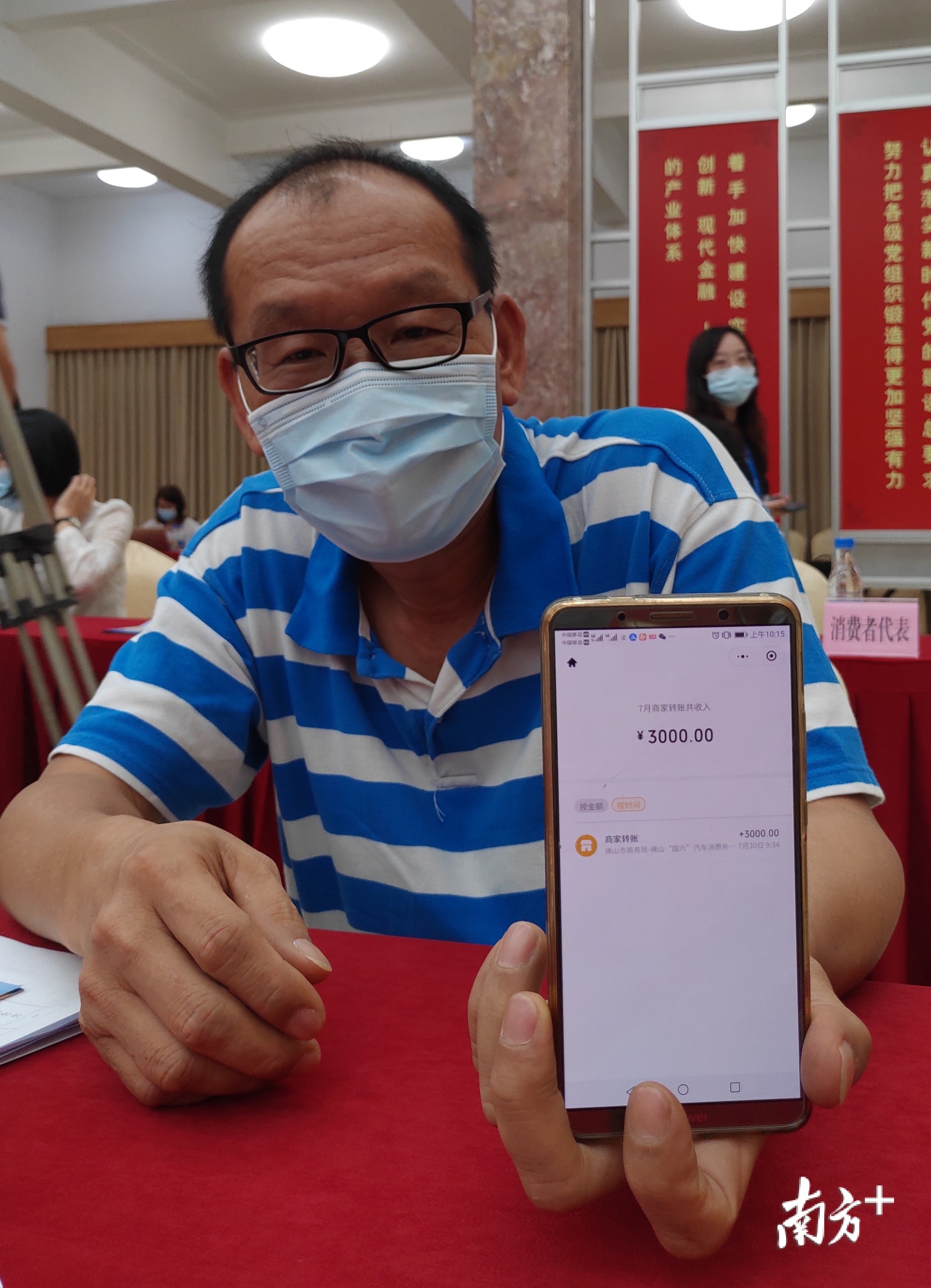 佛山市民展示收到的购车补贴。王谦 摄 佛山市民展示收到的购车补贴。王谦 摄