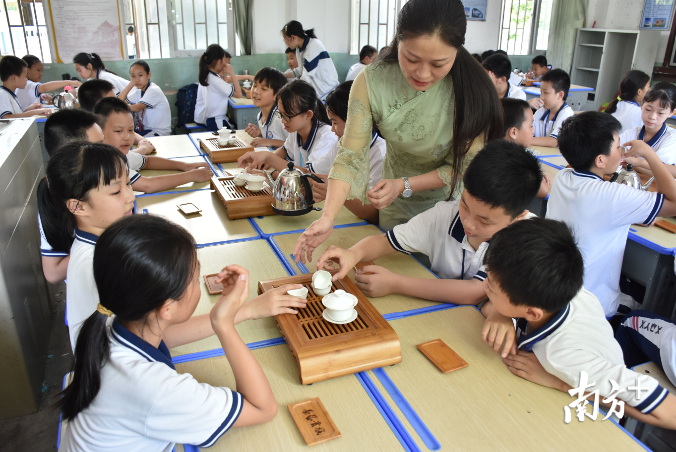 在意溪镇中心小学,潮州工夫茶艺传承人李淡榆教授孩子们冲泡工夫茶。 在意溪镇中心小学,潮州工夫茶艺传承人李淡榆教授孩子们冲泡工夫茶。