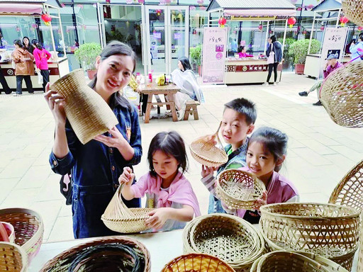 东莞市民在洋篮展位前拿着手工精致的洋篮编织品爱不释手。（高要文化馆供图）