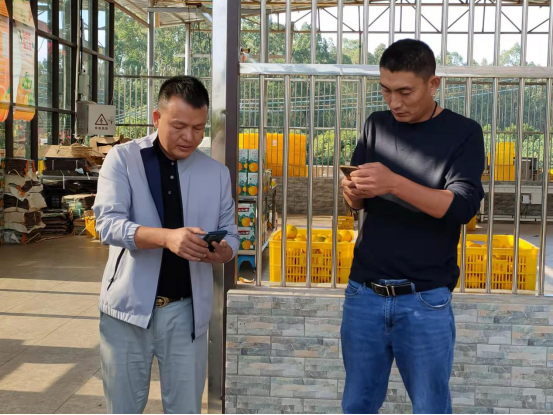 梁飞龙（左）正在跟来往的客商核对订单