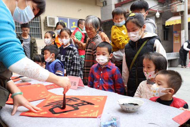 青年书法家在现场挥毫送福字。