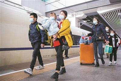 春运首日，广州南站，旅客提着大包小包的行李踏上回家之路。