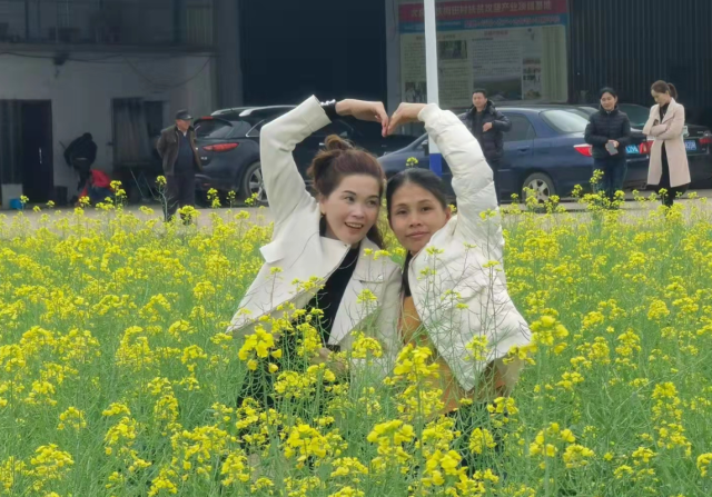 游客们在油菜花田合影