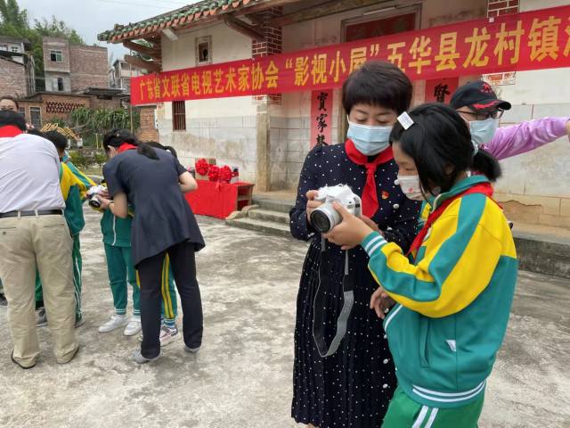 王宏芳教孩子使用相机