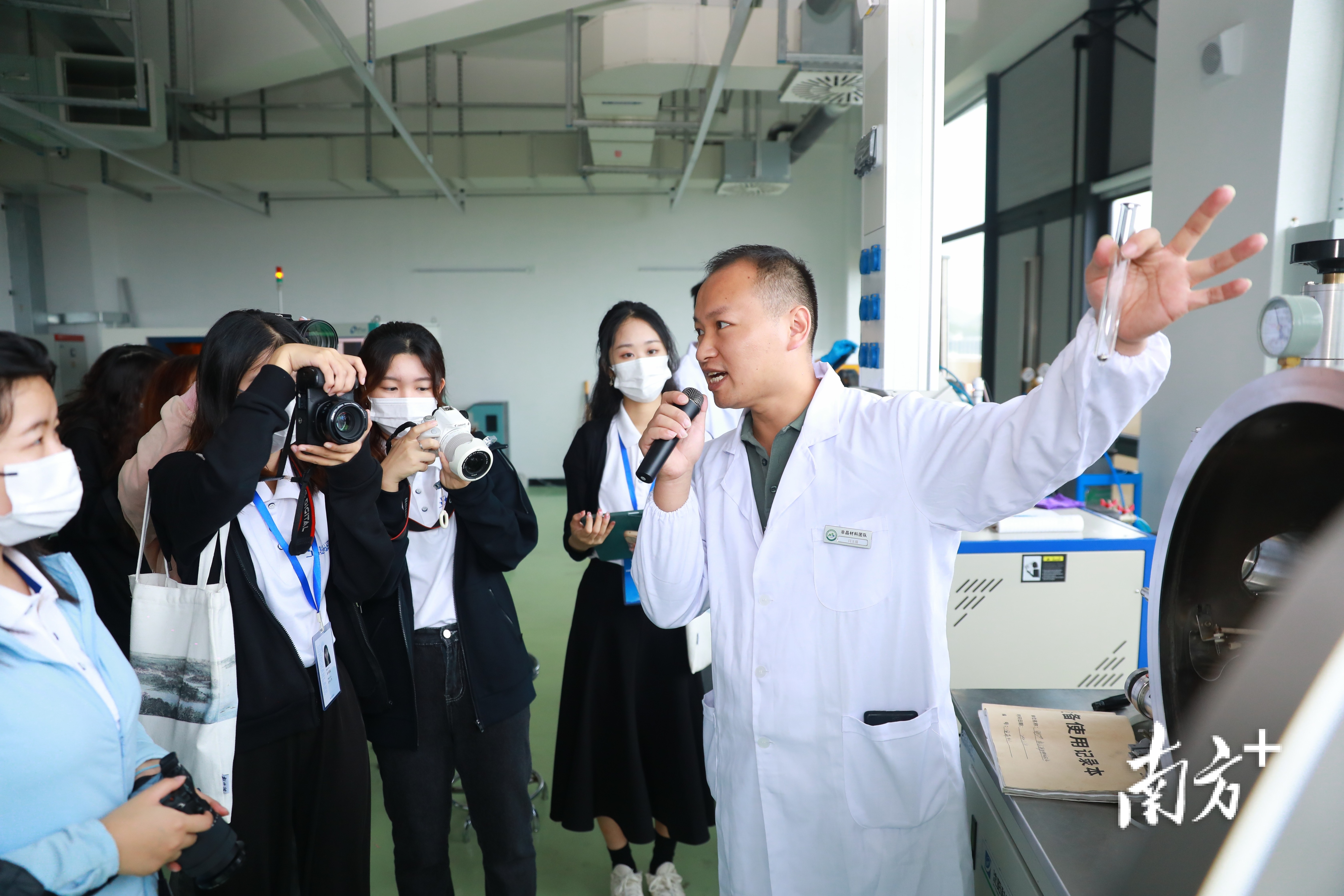 闫玉强向校媒特训营大学生记者讲解、展示非晶材料。