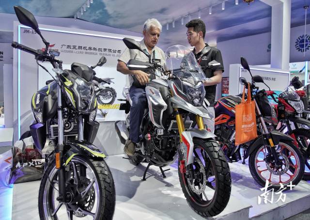来自广东江门的摩托车展位吸引了境外采购商前来"试驾".
