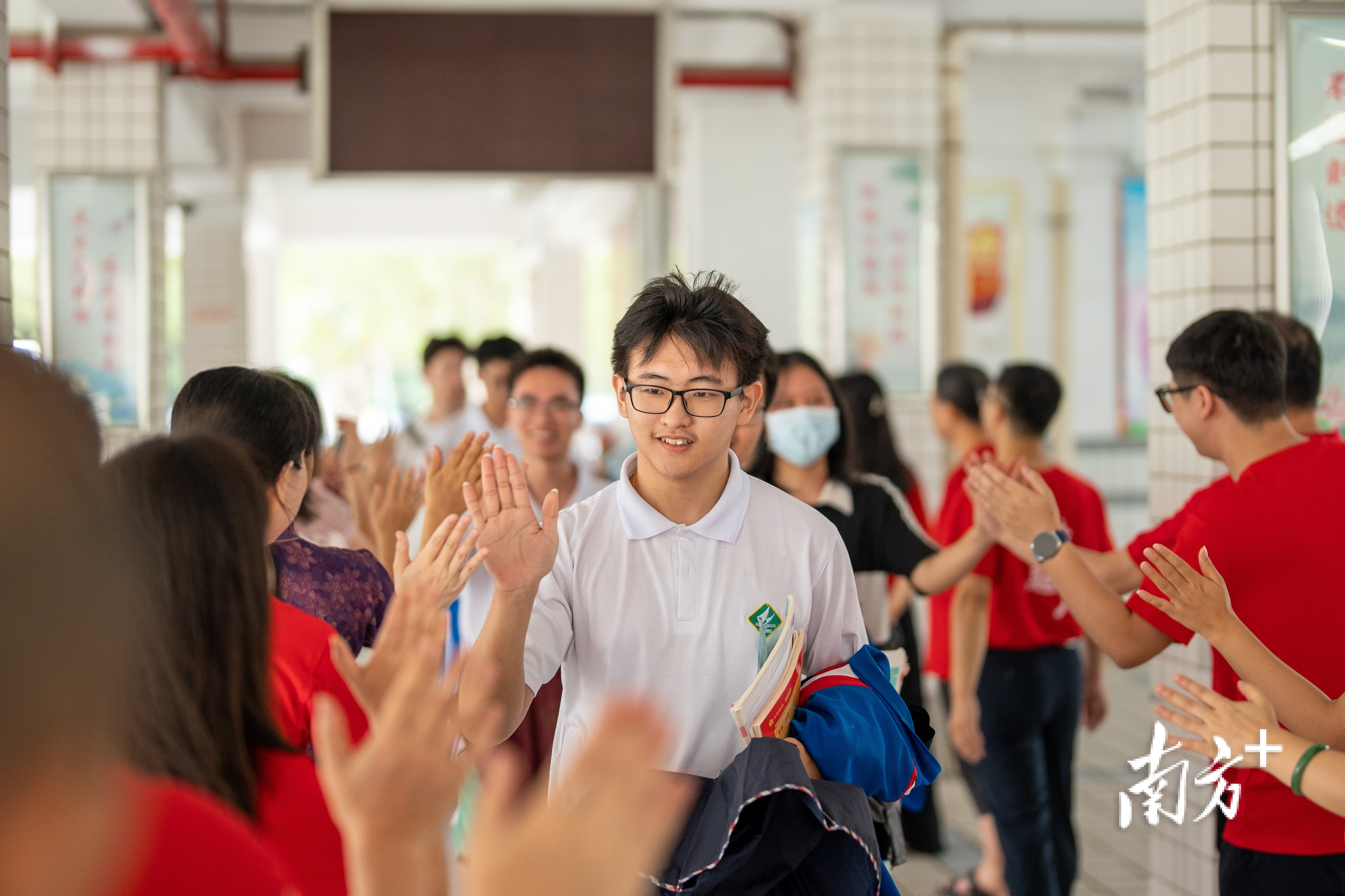 广东肇庆中学教师在高三楼一层排成一队，和考生拍手鼓励送祝福。肇庆发布 廖文奕 摄