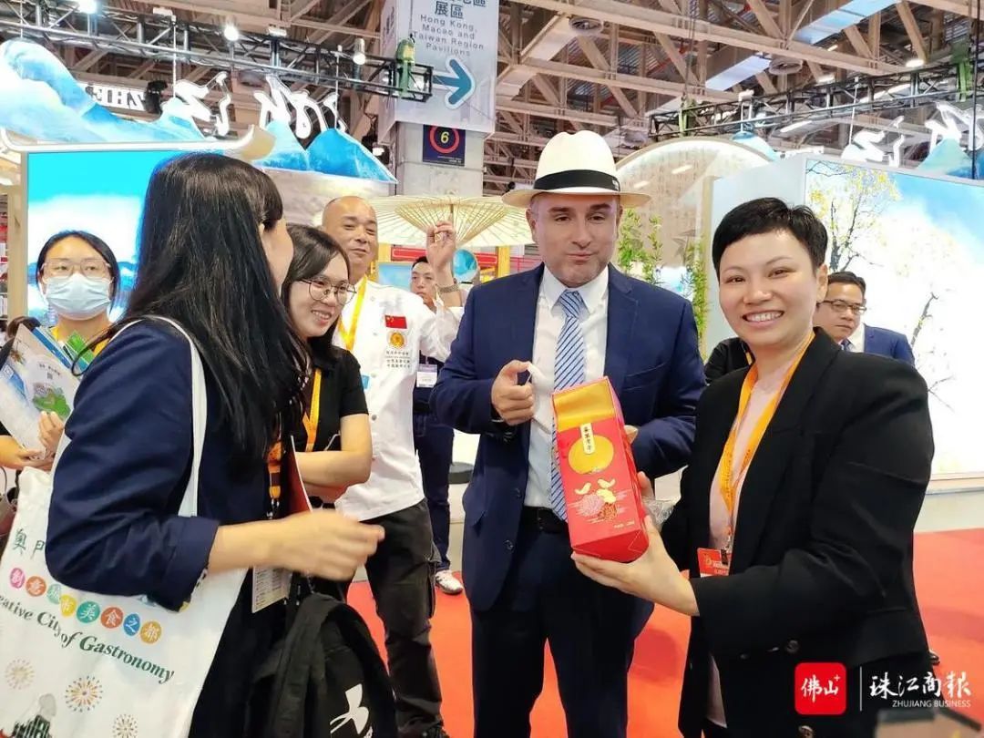 顺德区委宣传部（区文化广电旅游体育局）副部长刘莉向Eduardo介绍喜万年年的故事。