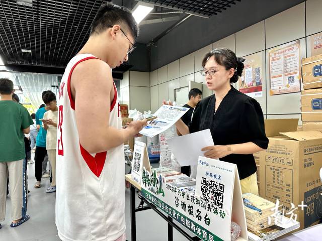 工作人员向新生发放活动邀请函。 