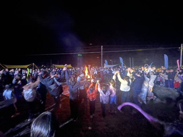 篝火晚会上，市民手拉着手起舞